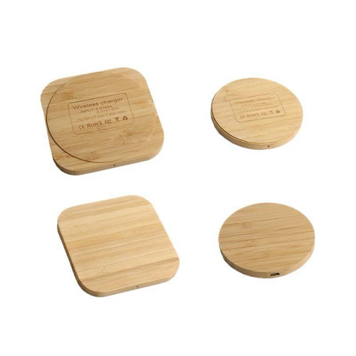 Set of four wooden wireless chargers on a white background